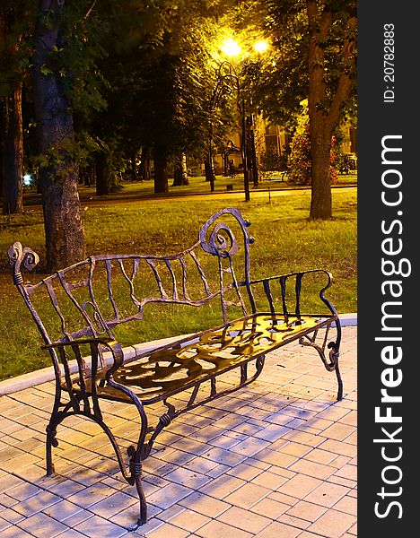 The steel forged bench in the park at night & silence. The steel forged bench in the park at night & silence