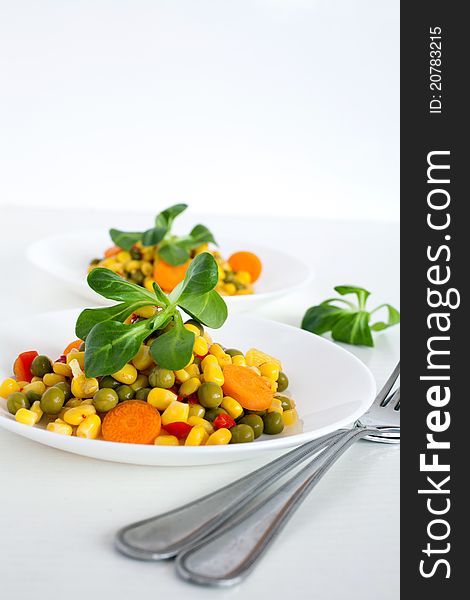 A vegetarian salad with corn, carrot, green peas and sweet pepper. A vegetarian salad with corn, carrot, green peas and sweet pepper