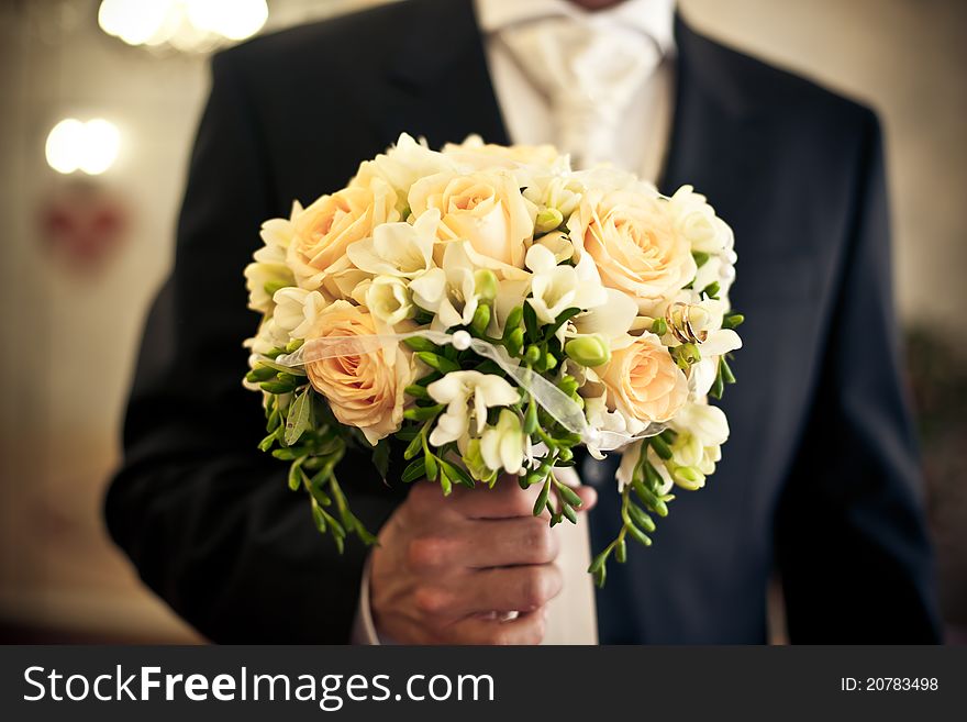 Wedding bouquet in groom's hands, yellow,orange