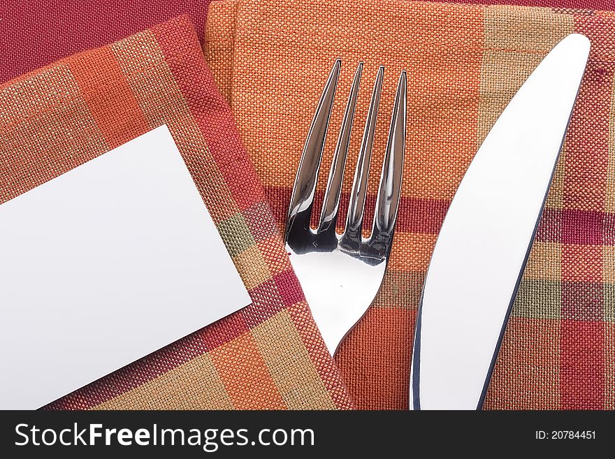 Knife and fork on a redk napkin - tableware.