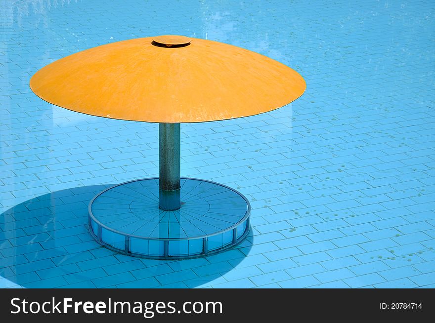 Small sunshade in swimming pool, shown as intersting color comparing and shape composition.