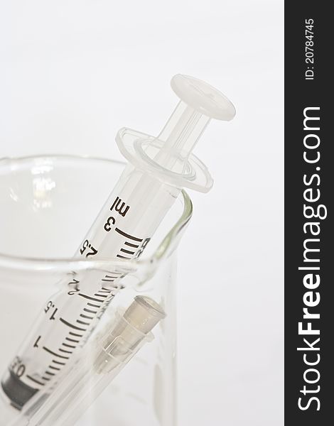 Syringe in the medical glass