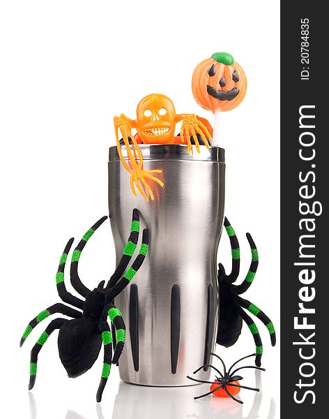 Halloween cup with spiders, hell candies, skeleton, lollipop on a white background. Halloween cup with spiders, hell candies, skeleton, lollipop on a white background