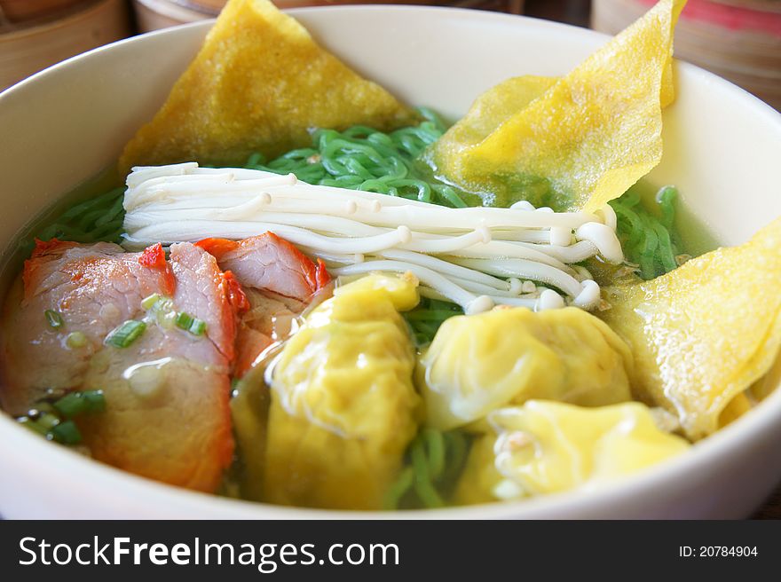 Close up green chinese noodle with slided pork