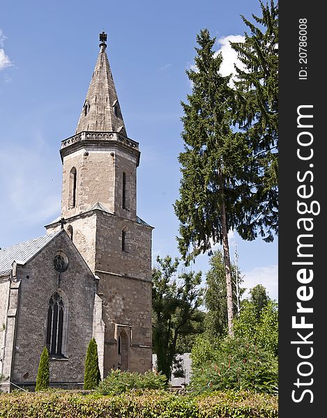 Architecture of the old stone church on the summer sunny day.