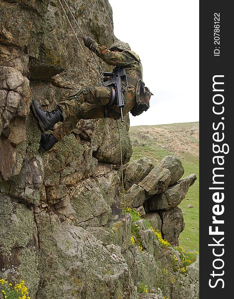 Armed Military Alpinist Climbing