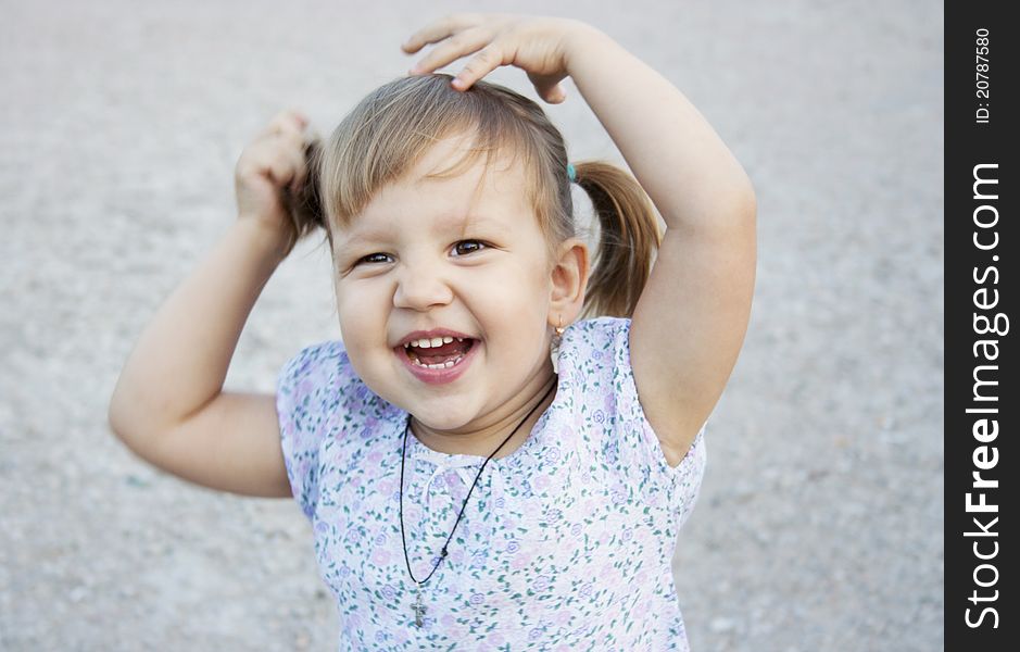 Portrait of blonde little girl outdoors