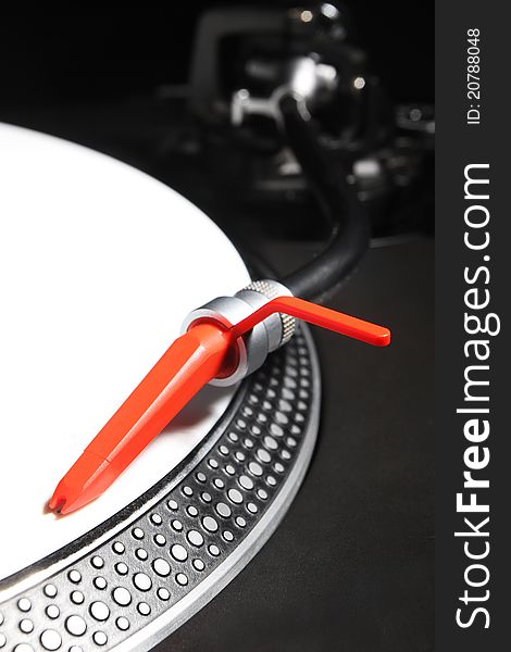 Professional direct-drive turntable record player with white viny timecode and red spheric needle. Professional direct-drive turntable record player with white viny timecode and red spheric needle