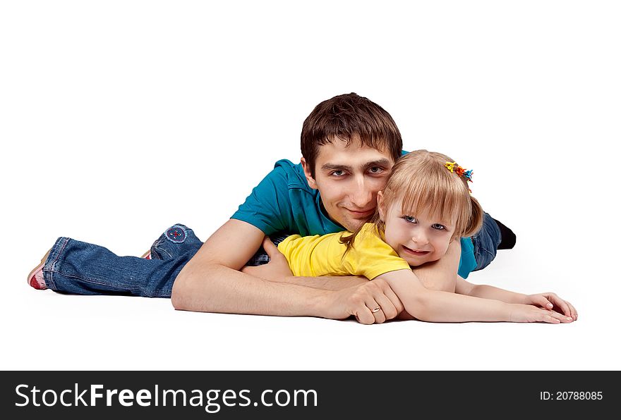 Dad and little daughter lying on the floor in the studio on a white background