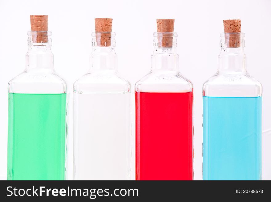 Three glass bottles of various colors