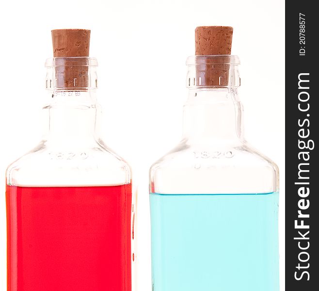 Three glass bottles with different colored liquids. Three glass bottles with different colored liquids