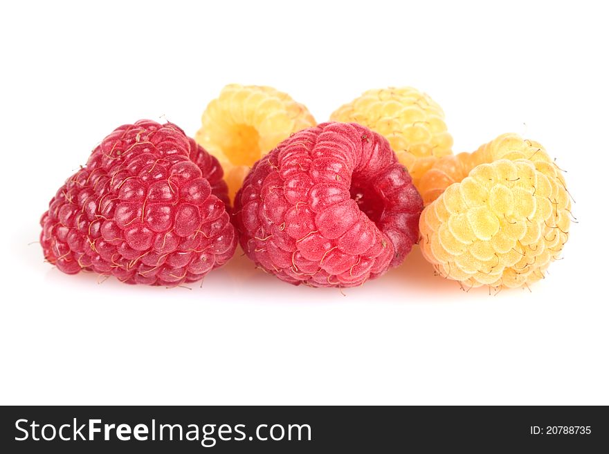 Red and yellow raspberries on white background