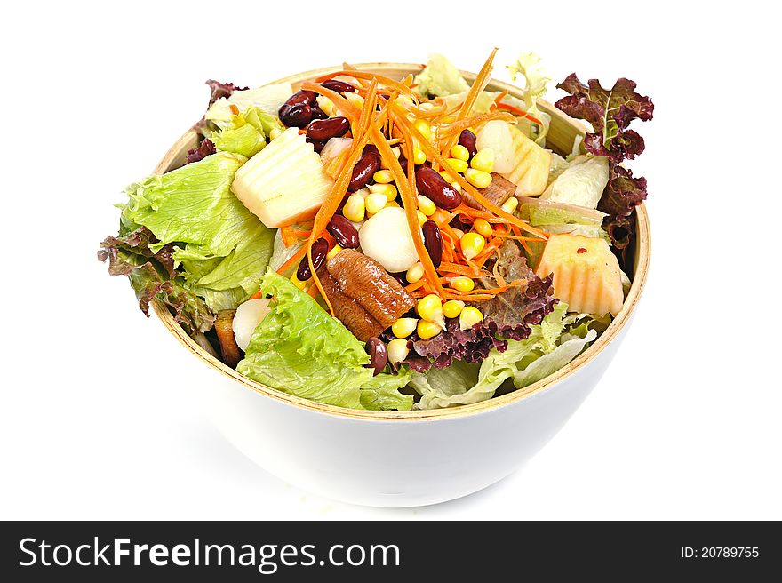 Mixed salad in salad bowl over white