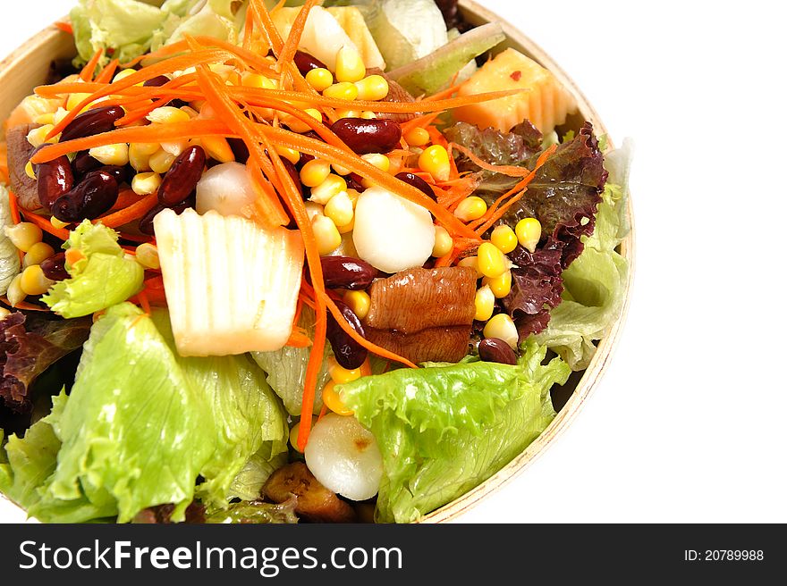 Mixed salad in salad bowl over white