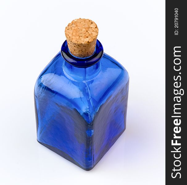 Empty blue bottle with cork