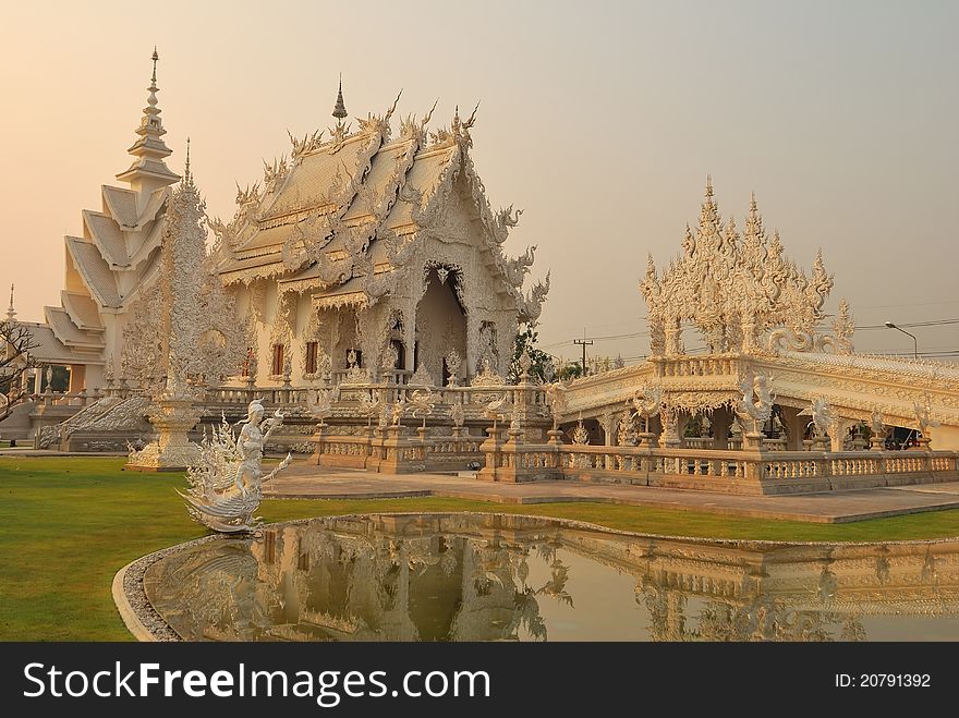 Majestic white Buddhist temple in Thailand built with intricate carvings. Majestic white Buddhist temple in Thailand built with intricate carvings.