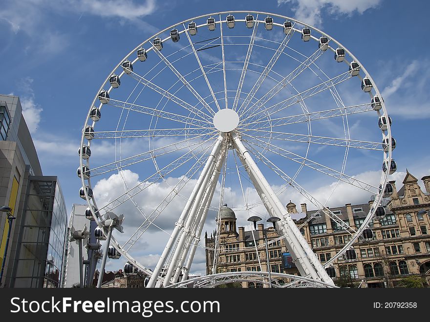 A Fairground Wheel on a city shopping plaza. A Fairground Wheel on a city shopping plaza