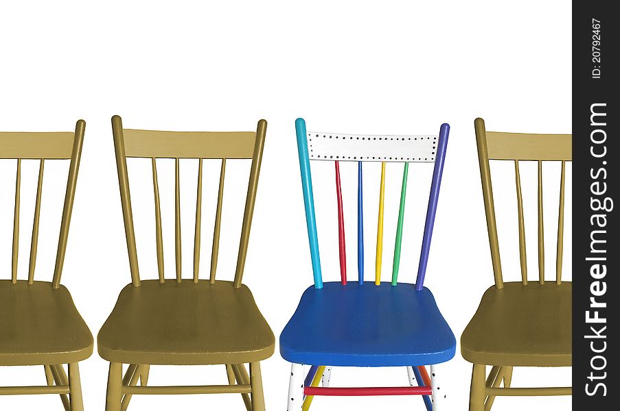 Four Chairs, three brown, one colorful