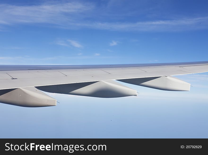 Wing of the plane on a background of sky