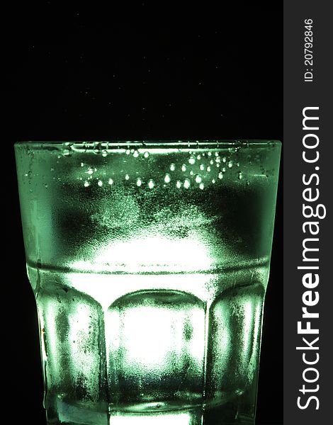 A glass cup with black background.