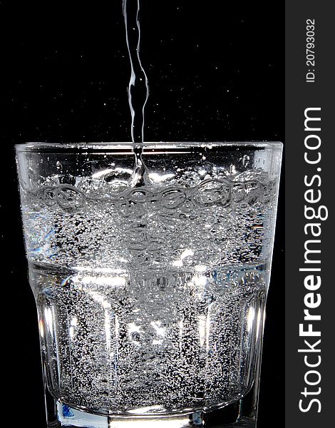 Water being poured into a glass.