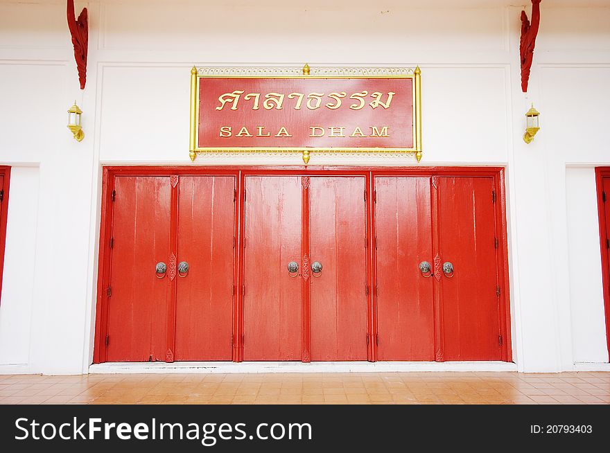 Red doors cosed with old latch at Chiang Mai University, Thailand.