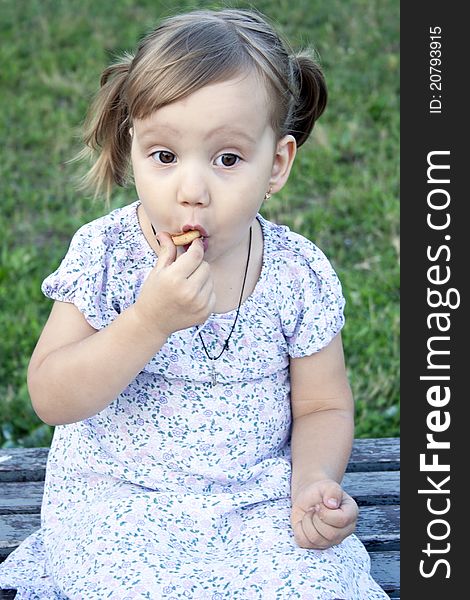 Portrait of blonde little girl outdoors