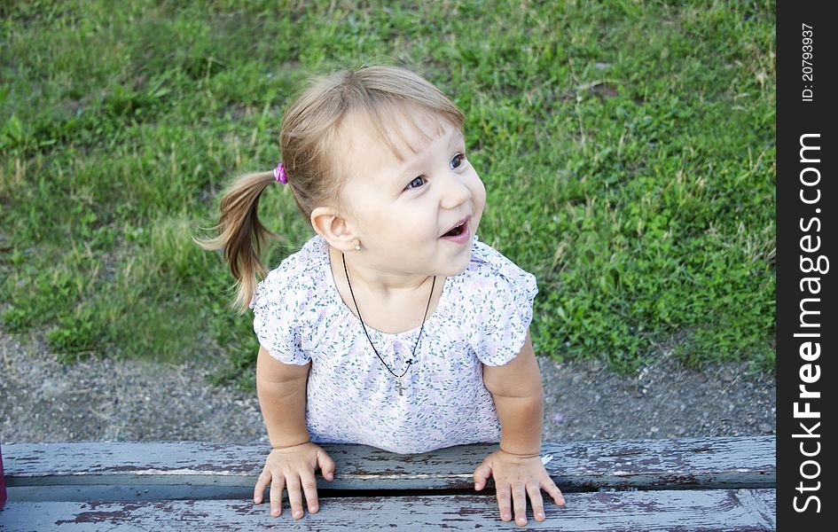 Portrait of blonde little girl outdoors