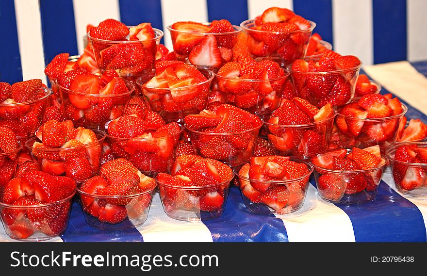 A Display of Strawberries in Small Plastic Bowls. A Display of Strawberries in Small Plastic Bowls.