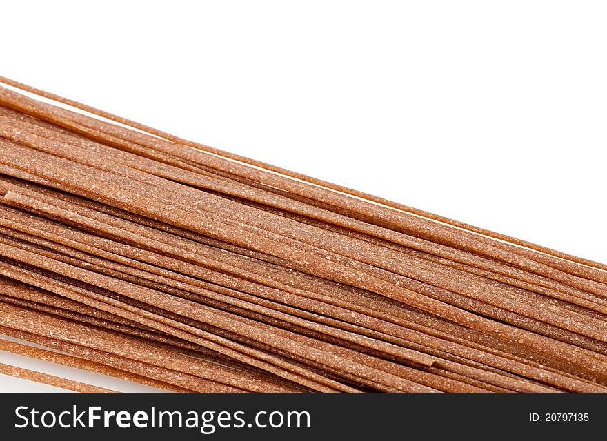 Close up of whole wheat pasta isolated on white background with copy space. Close up of whole wheat pasta isolated on white background with copy space