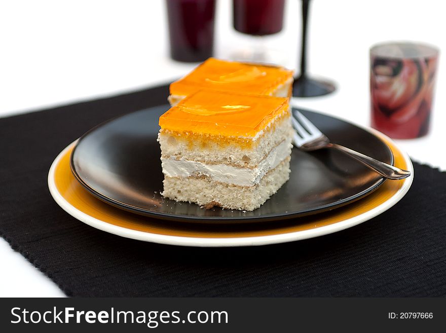 Dessert - Orange Cheesecake on black plate
