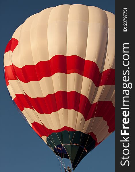 Image of a red, white and blue flag balloon flying. Image of a red, white and blue flag balloon flying