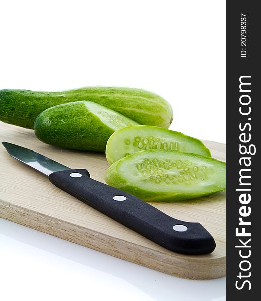 Cucumber sliced with kinfe on chopping board. Cucumber sliced with kinfe on chopping board