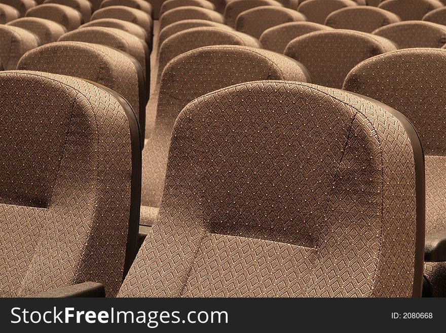 Close-up image of rows of seating in a large auditorium. Close-up image of rows of seating in a large auditorium