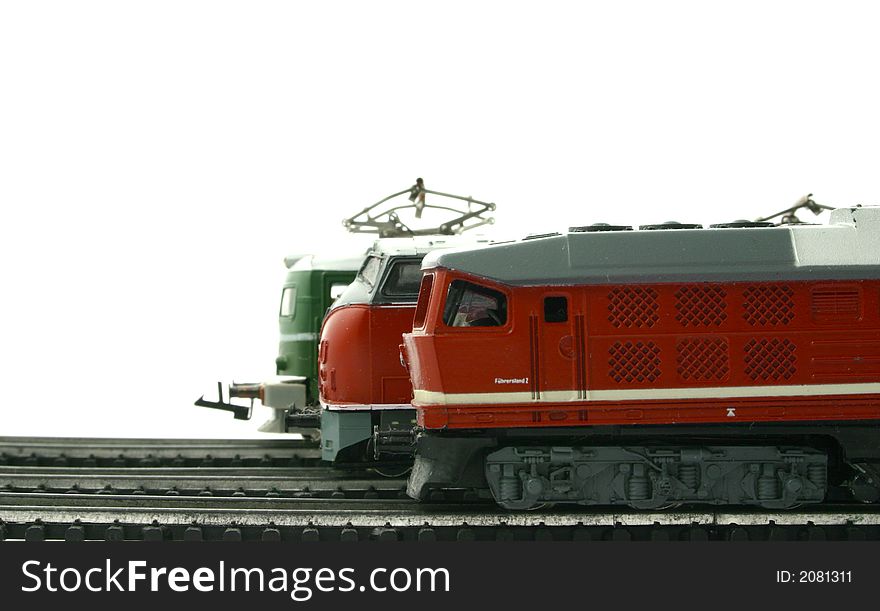Three models of locomotives starting to move on the rails. Three models of locomotives starting to move on the rails