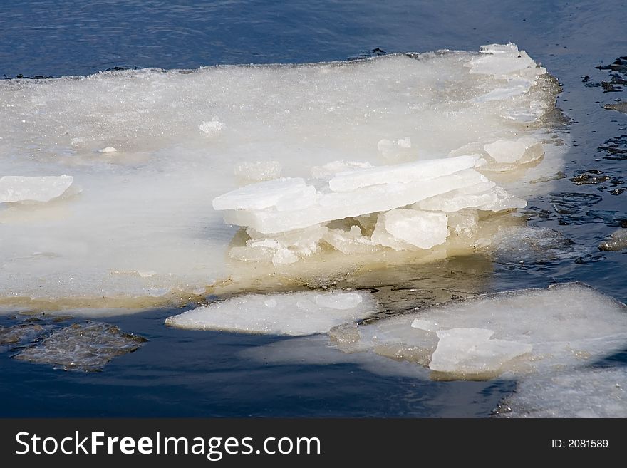 Melting ice flowing down a thawing river in spring. Melting ice flowing down a thawing river in spring