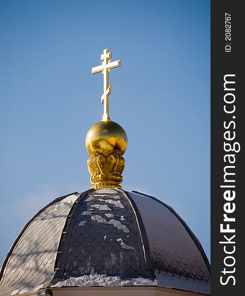 Dome of a chapel and cross on a background of the sky