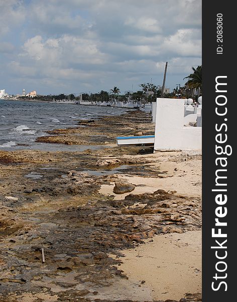 Rocky shoreline of cozumel mexico on a clear day.