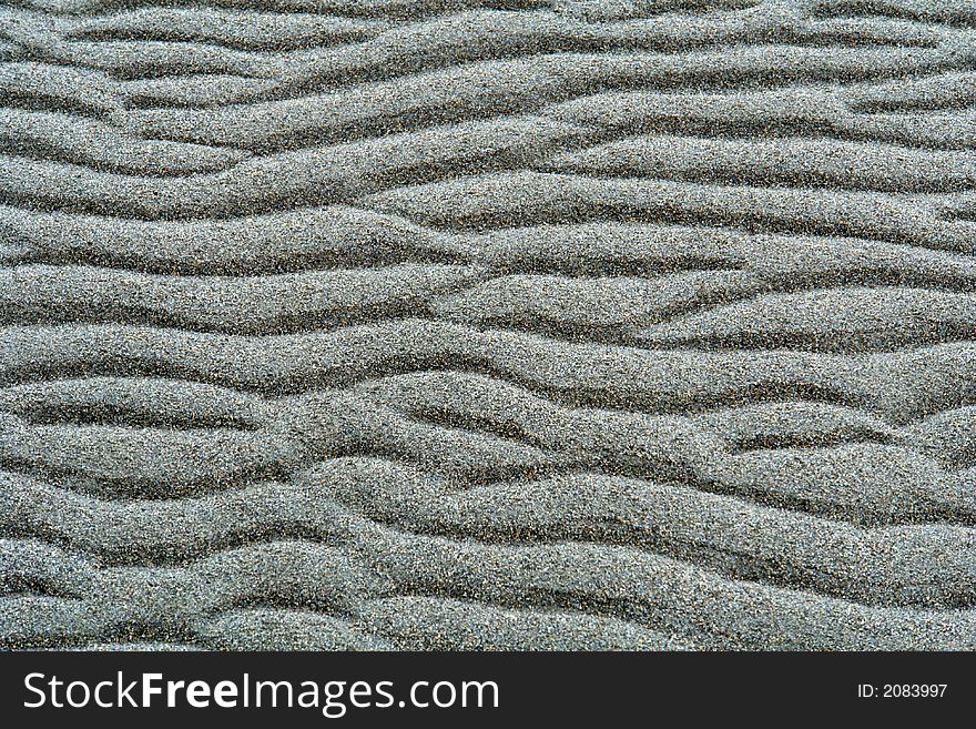 Small wave ripples in the sand at low tide. Small wave ripples in the sand at low tide