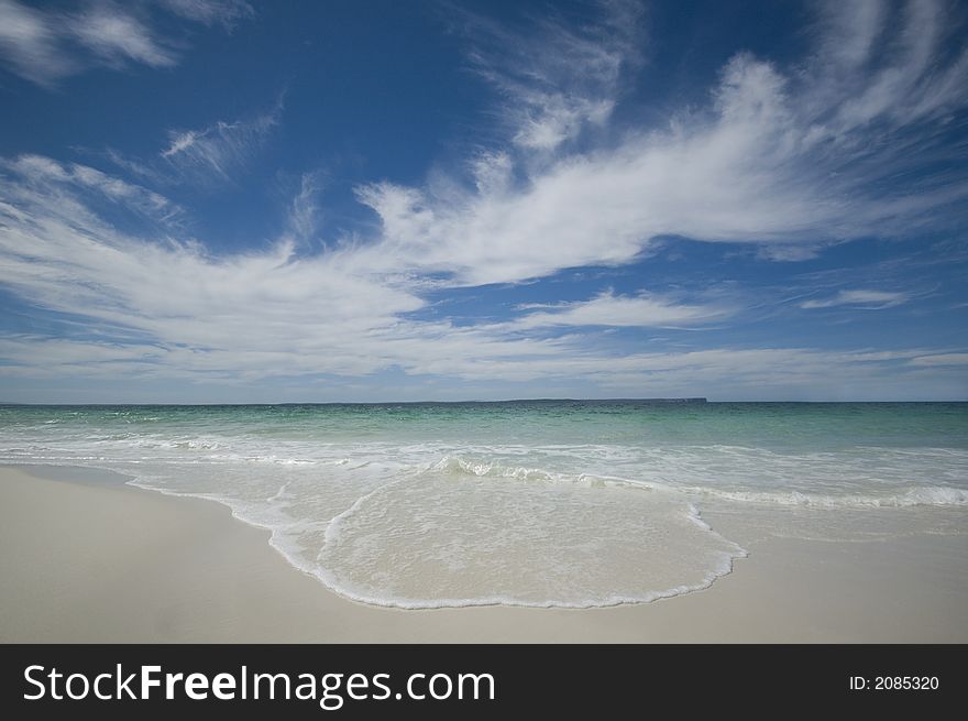 Closeup view of waves crashing on a tropical beach. Closeup view of waves crashing on a tropical beach