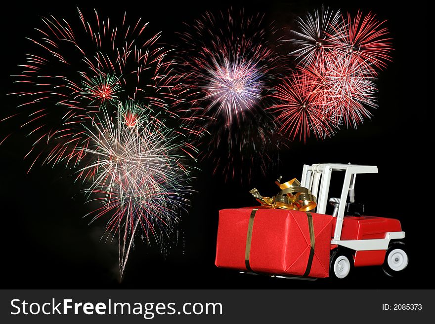 Picture of a forklift toy car bringing a gift with fireworks on the background. From my brothers toy collection. Made in the 1970's. Picture of a forklift toy car bringing a gift with fireworks on the background. From my brothers toy collection. Made in the 1970's