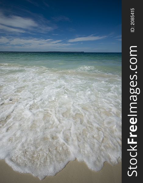 Closeup view of waves crashing on a tropical beach. Closeup view of waves crashing on a tropical beach