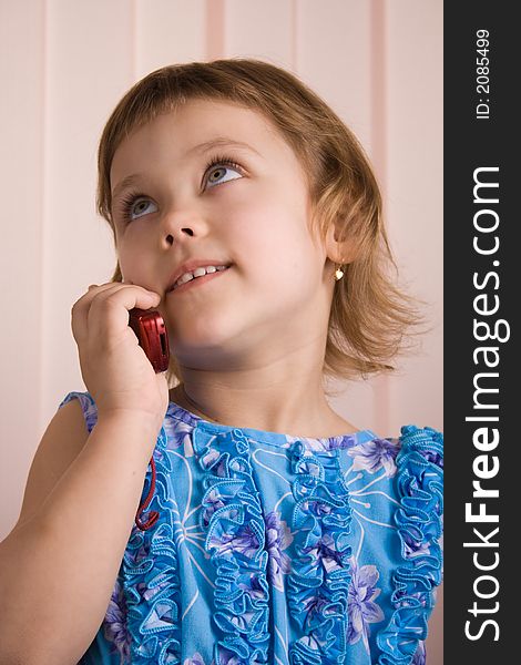Little girl talking at phone
