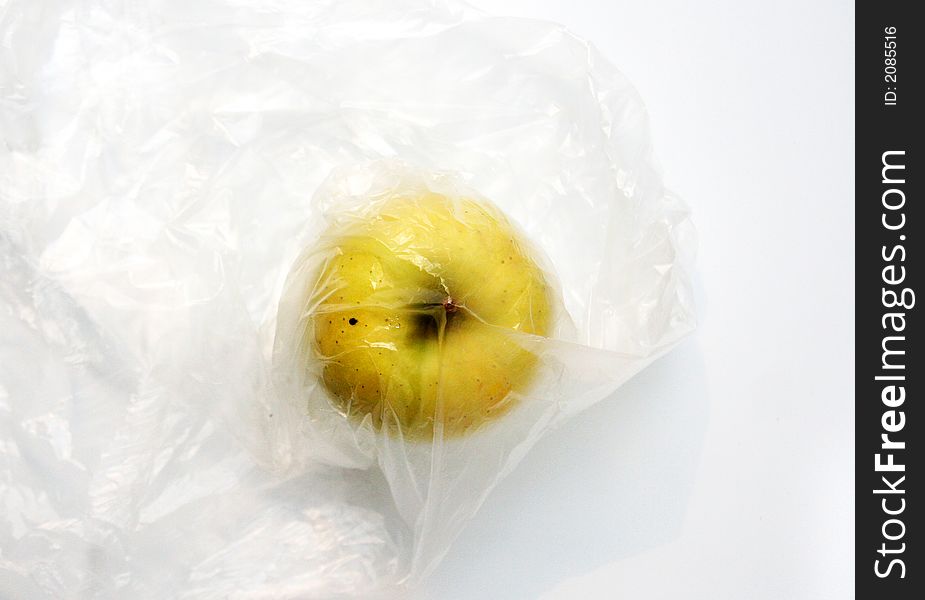 Yellow apple in the plastic bag