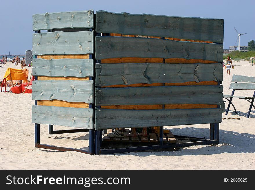 Green wooden beach cabin in sandy coastline. Green wooden beach cabin in sandy coastline