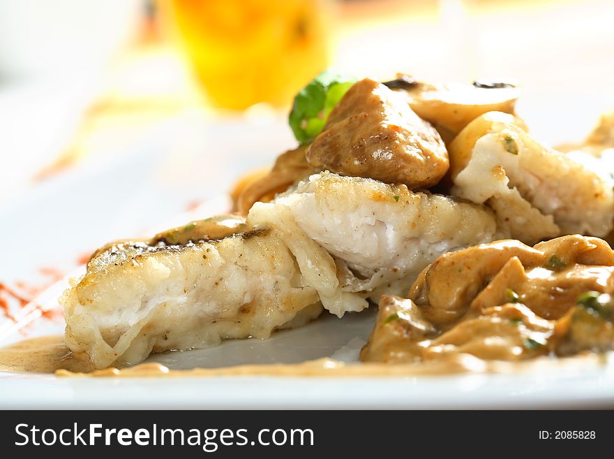 Delicious zander with boletus dressing on the white plate