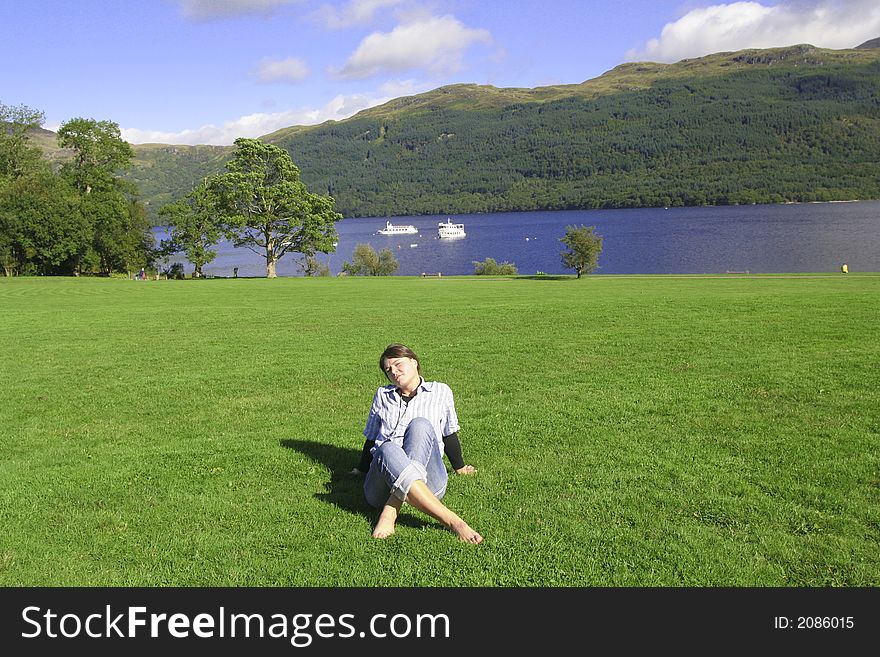 Smiling woman relaxes on the grass