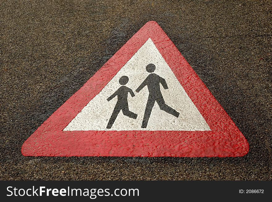 Sing on the pavement of a road to warn drivers for crossing children. Sing on the pavement of a road to warn drivers for crossing children