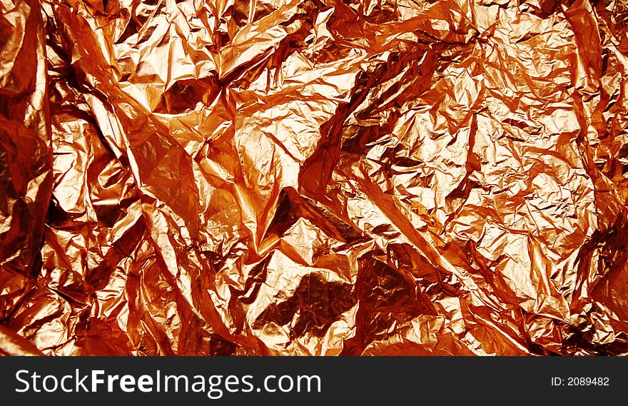 Crumpled gold leaf, abstract color background. Crumpled gold leaf, abstract color background