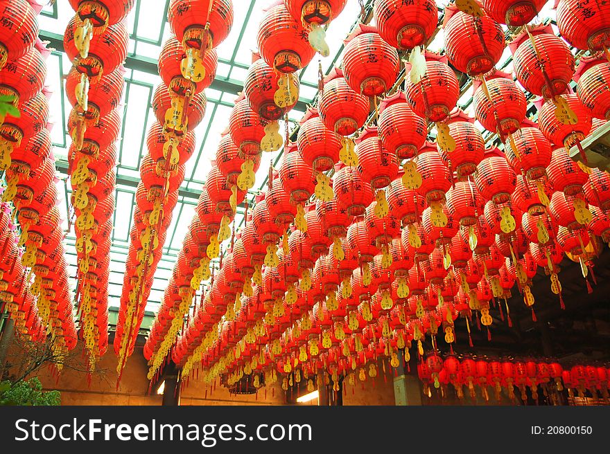 Many red lanterns hang in the temple. They bring good luck and peace to prayer. Many red lanterns hang in the temple. They bring good luck and peace to prayer.
